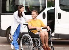 Doctor Talking And Taking Care Of Patient In Wheel Chair