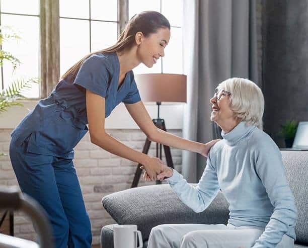 Nurse Helping Elderly Woman Stand