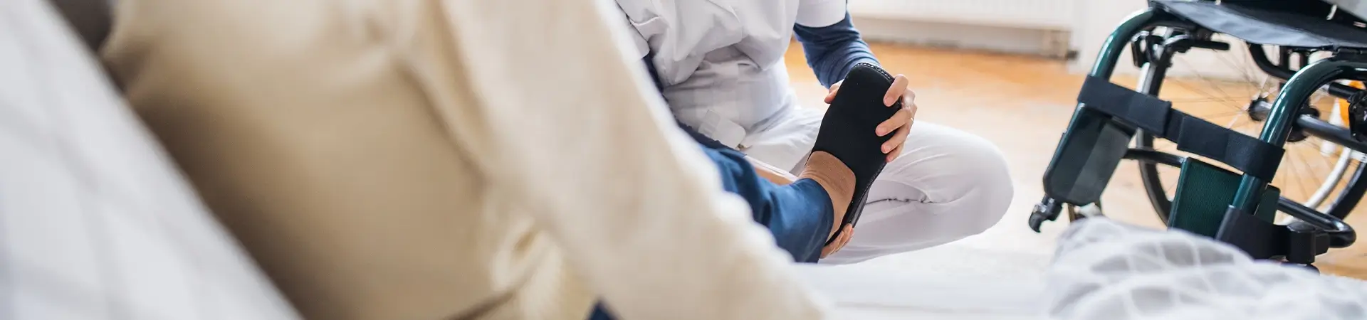 Nurse Assisting Patient Holding Foot Wheelchair Healthcare