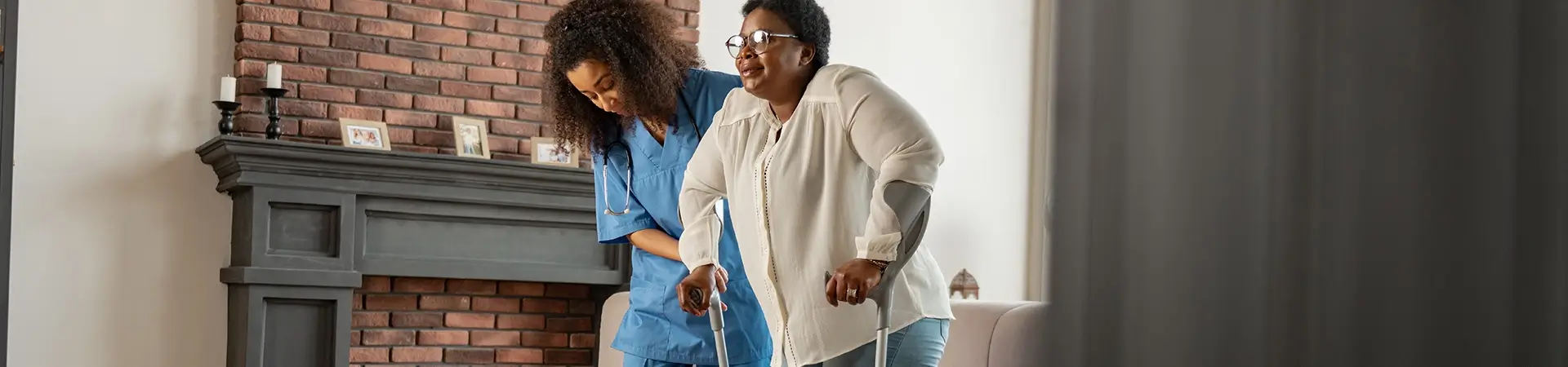 Nurse Helping Patient With Crutch In Home Care